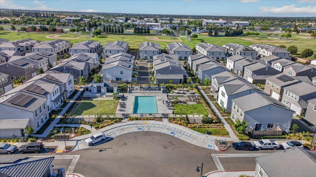 Authentic aerial of the gated complex and community pool, from the sold Wisteria listing; not a photograph of Honeysuckle